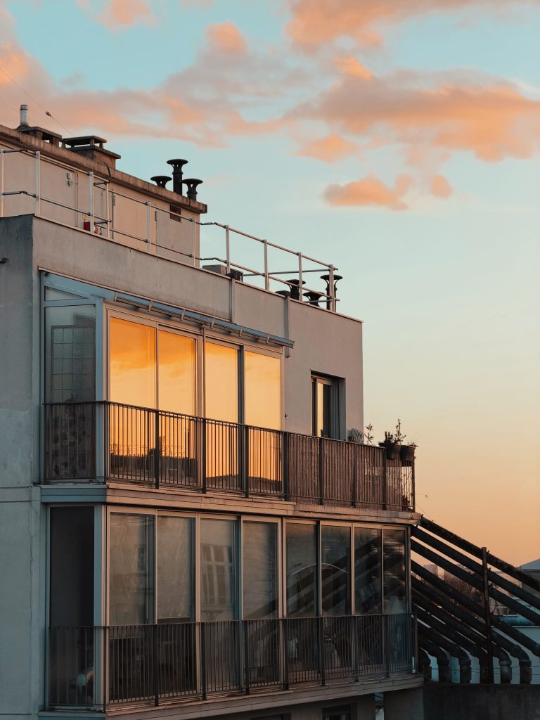 Beautiful sunset reflecting on a contemporary building's glass windows.